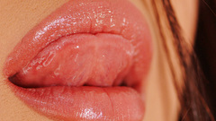 Lips licking tongue