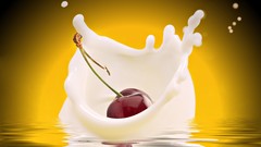 Liquid milk cherries yellow background fruits splashes