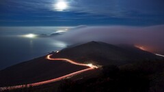 long exposure landscape clouds road street light coast night sky