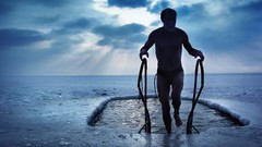 Men ice skies frozen lake