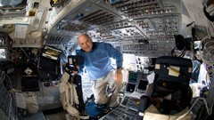 Men inside spaceships cockpit wide-angle