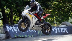 Men jumping motorcycle vehicle