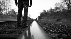 Men track chains railroad tracks grayscale