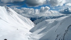 Mountains clouds snow valley