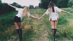 Nature woman couple blondes brunettes holding hands knee socks