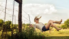 Nature woman fences blondes boots floating denim shorts
