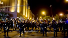 Night Horses police streets protest conflict tilt-shift 