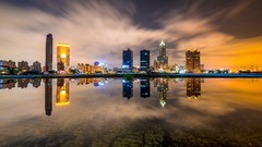 Night water lights ships Skyscrapers reflections buildings 