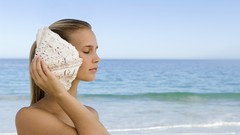 Ocean woman blondes seashells listening