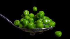 Peas black background vegetables spoons
