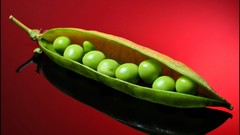 Peas vegetables red background