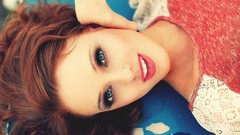 Pink woman faces redhead blue eyes