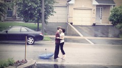 Rain couple kissing barefoot streets
