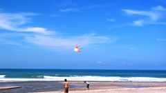 Sand Sea nature ocean kite couple Beaches skies blue skies 