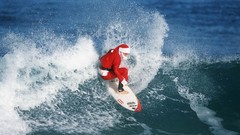 Santa surfing waves
