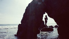 Sea woman silhouettes rocks arches sunlight models