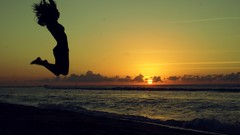 Silhouettes jumping arms raised