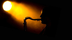Silhouettes spotlight saxophones musicians
