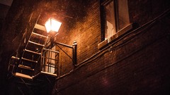 Snow windows urban lanterns brick wall stairways