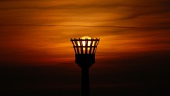 Sun silhouettes skies