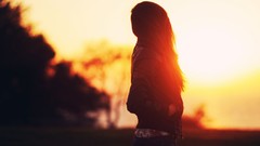 Sun woman jeans silhouettes sunlight long hair blurred 