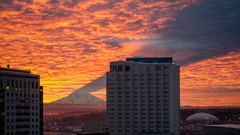 Sunrise clouds buildings shadows Mount Rainier