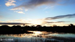 Sunrise yellow water black blue clouds silhouettes skies