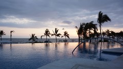 Sunset Mexico palm trees swimming pools