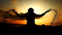 Sunset silhouettes arms raised