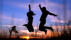 Sunset silhouettes jumping