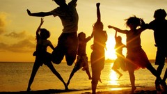 Sunset silhouettes jumping arms