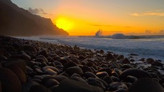Sunset stones gold coast Hawaii waves Kauai low-angle shot