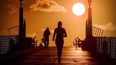 Sunset sun woman silhouettes jogging