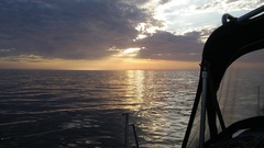 Sunset water clouds boat