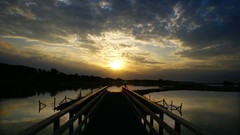 Sunset water sun clouds piers