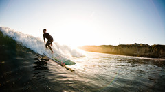 Sunset waves surfers