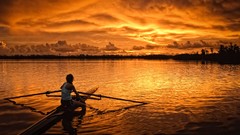 Sunset woman lakes rowing