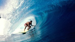 Surfing waves surfers