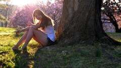 Trees woman sitting sunlight denim shorts