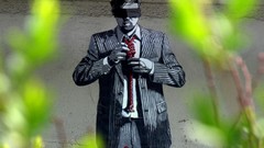 Wall Men paint graffiti Utopia tie suit urban streets protest 