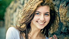 Wall woman Bricks shoulders smiling blue eyes brunettes