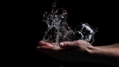 Water hands black background splashes