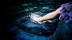 Water woman splashes legs barefoot purple dress