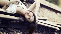 Woman asians lying down railroad tracks