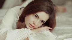 Woman beds brunettes white dress looking away