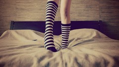 Woman beds legs striped legwear