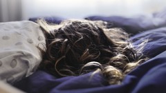 Woman beds lying down curly hair