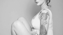 Woman beds monochrome tattoos