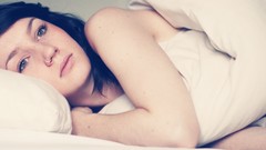 Woman beds piercings lying down