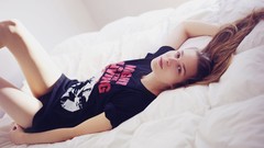 Woman beds t-shirts lying down